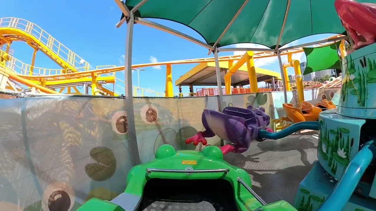 A family on the Freaky Frogs ride at Luna Park Sydney